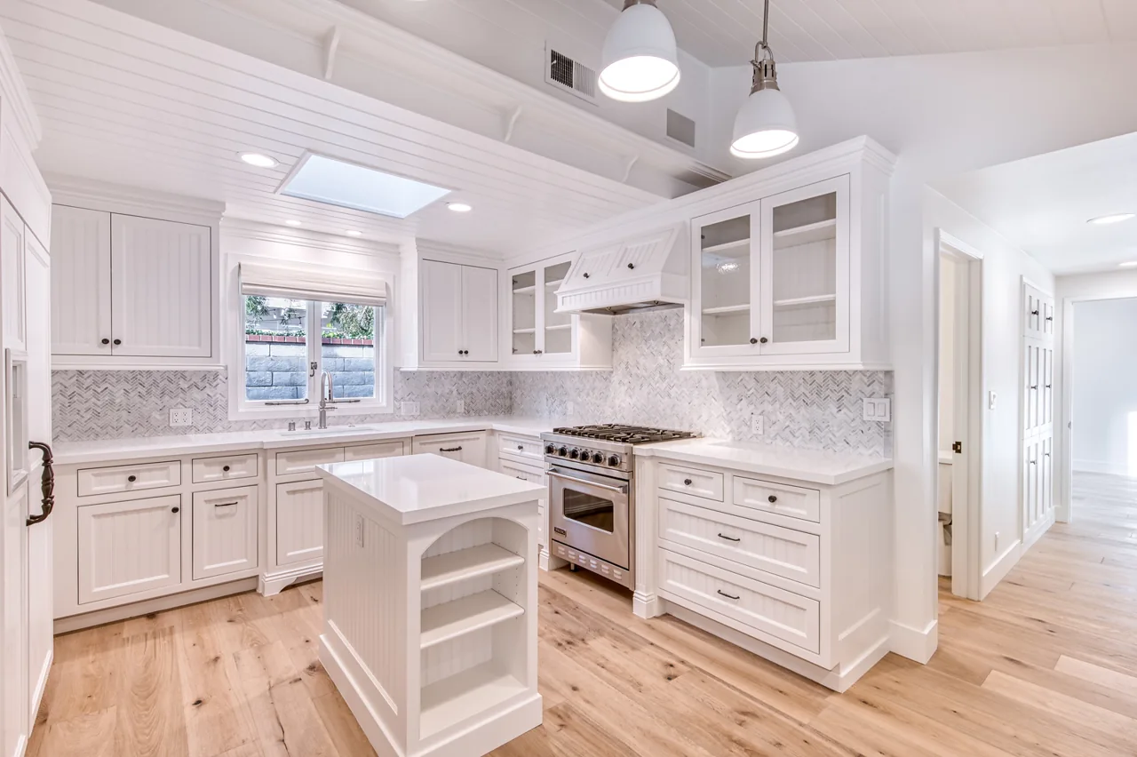 Kitchen with island and white cabinetry